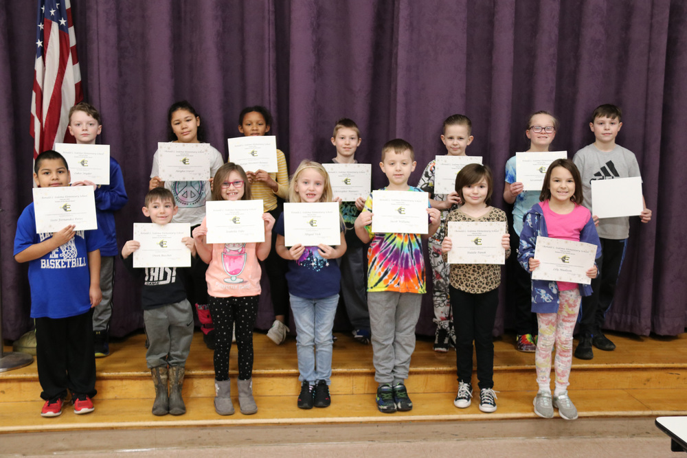 students of the month pose with certificates