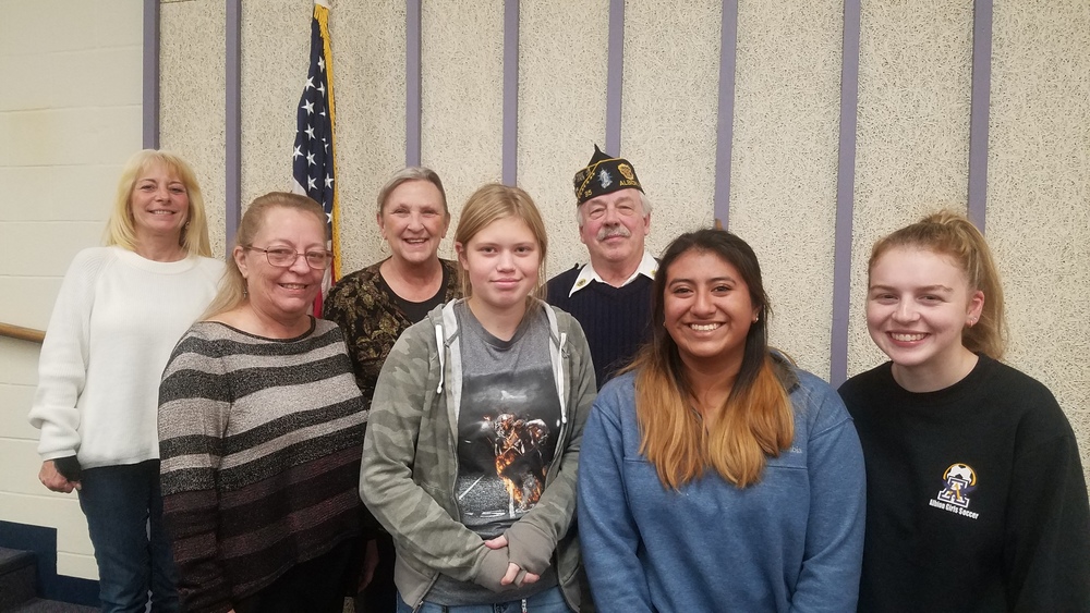 Aubrey Gannon, Jackie Santiago Garcia, and Lucy Rivers with four members of the American Legion.