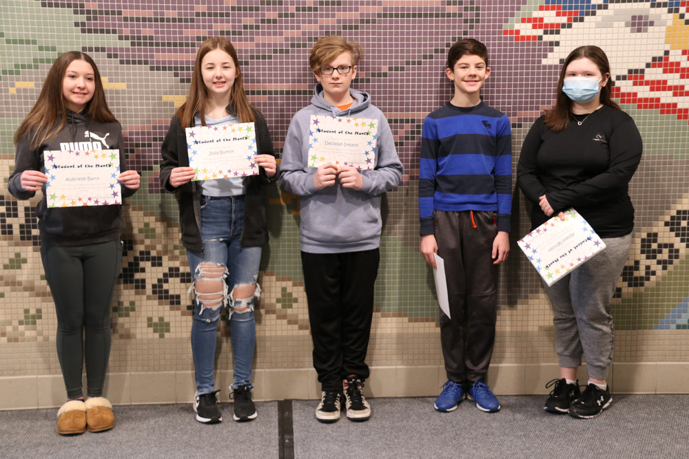 students of the month pose with their certificates