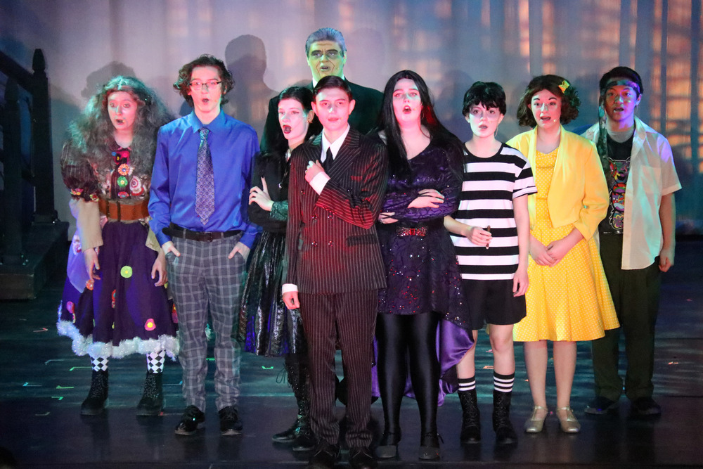the cast of The Addams Family performs on stage