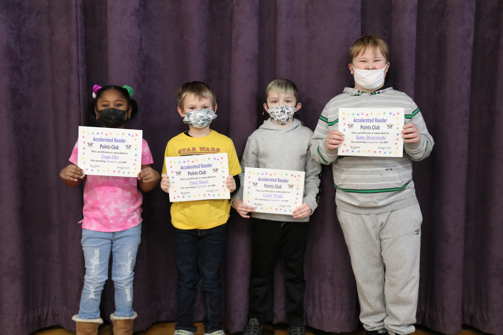 students pose with their accelerated reader certificates
