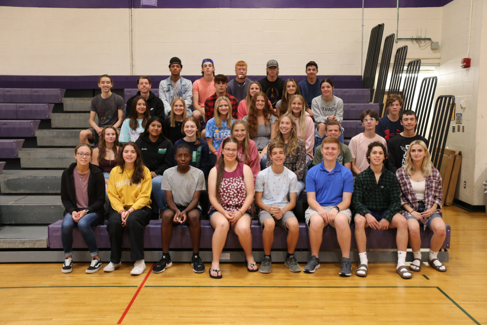 scholar athletes sit in the gym bleachers