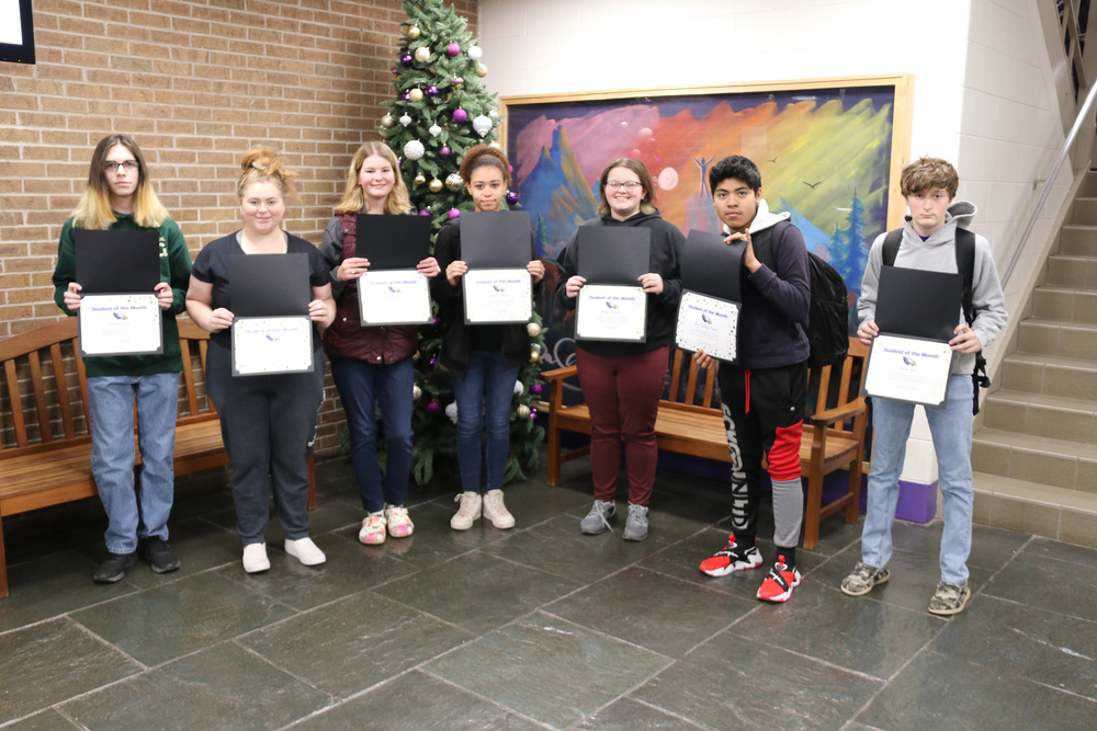 students of the month pose with their certificates
