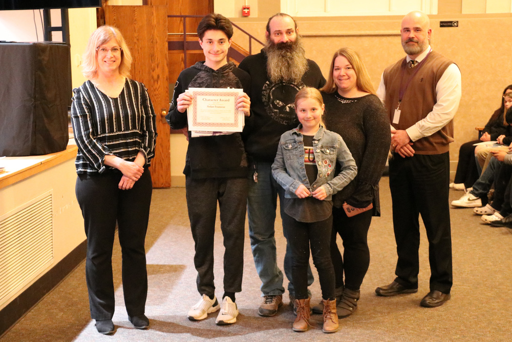 character award honoree recognized with parents by BOE president and superintendent