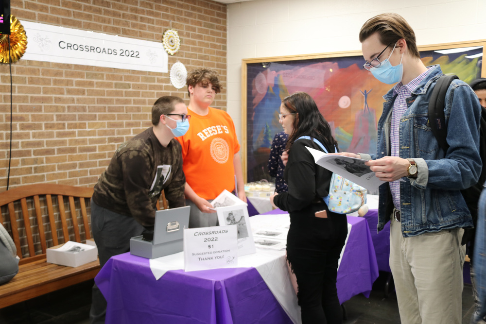 students sell and read the 2022 Crossroads magazine