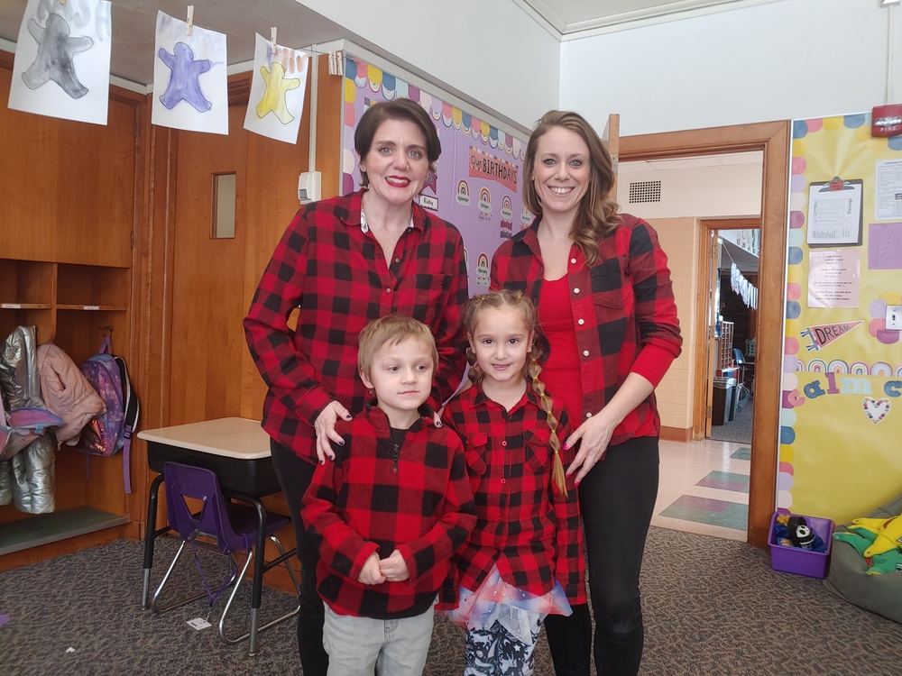 kindergarteners and teachers pose in matching shirts