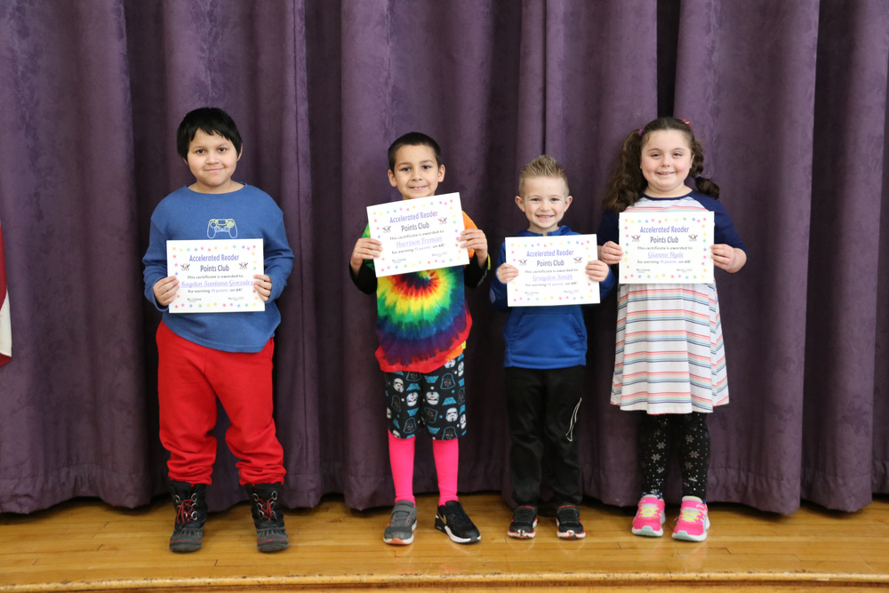 accelerated reader students pose with their certificates