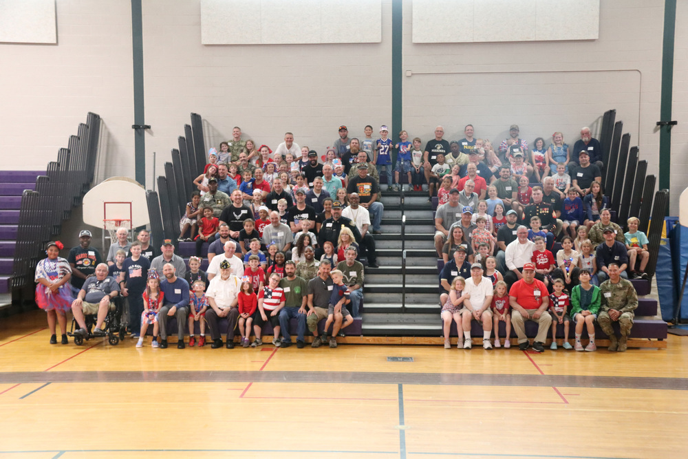 students and veterans gather for a group photo