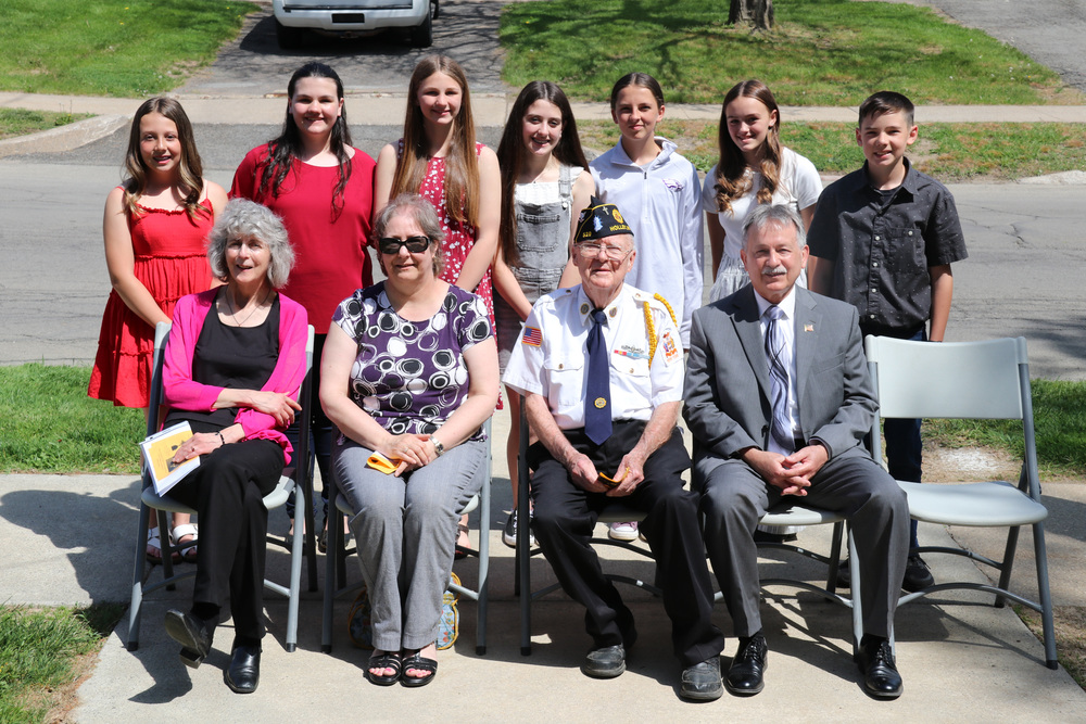 service learning students stand behind ceremony dignitaries