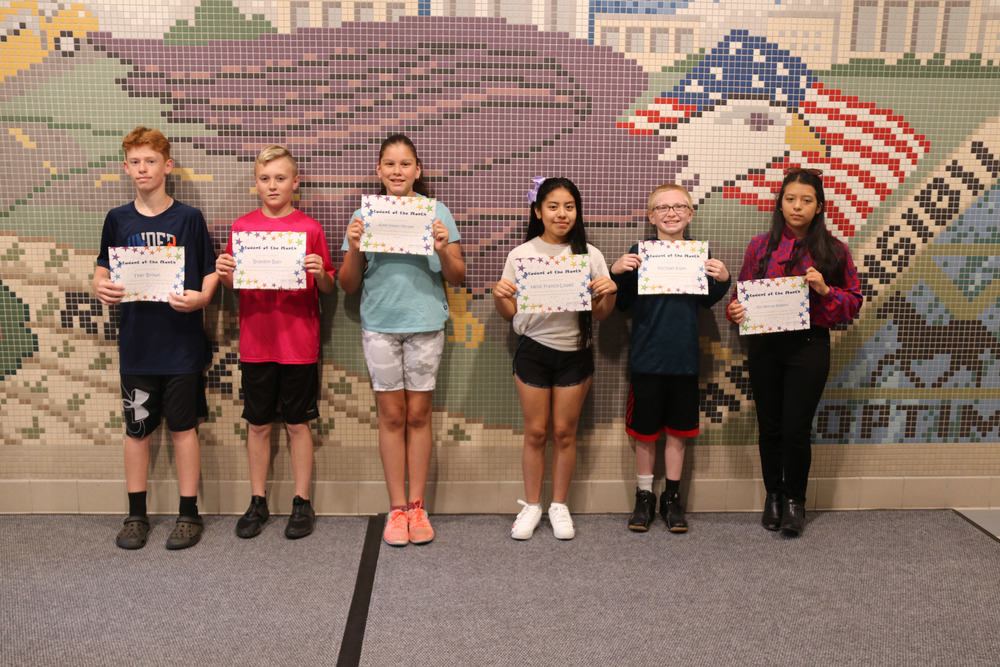 june students of the month with their certificates