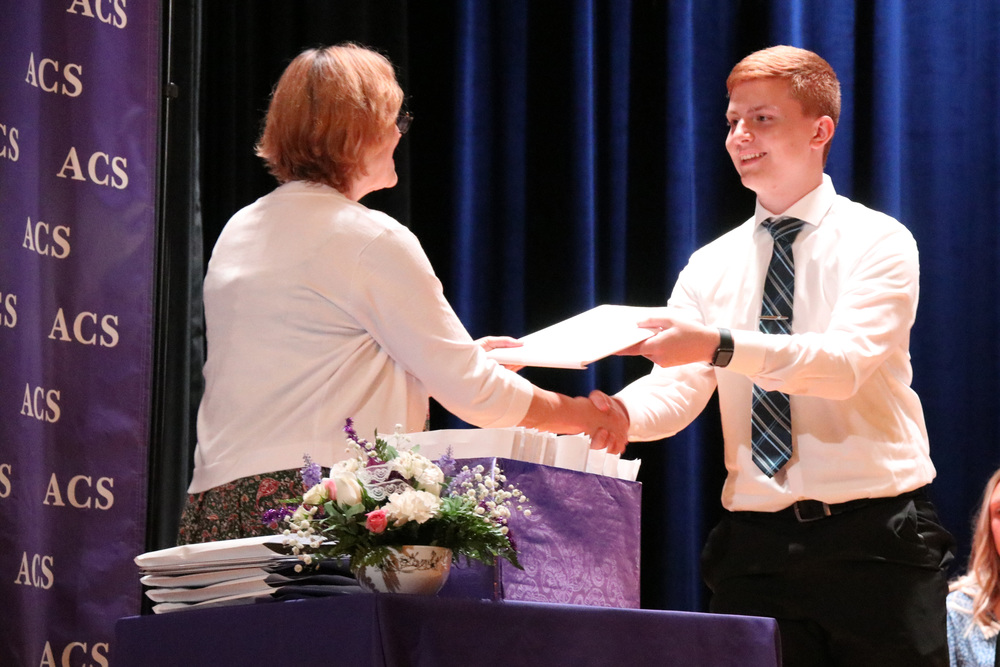 a senior accepts his award
