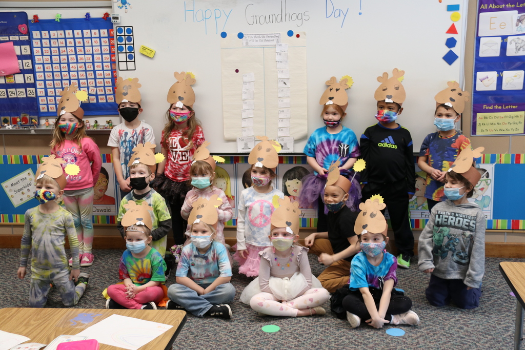 kindergarteners pose with groundhogs day hats