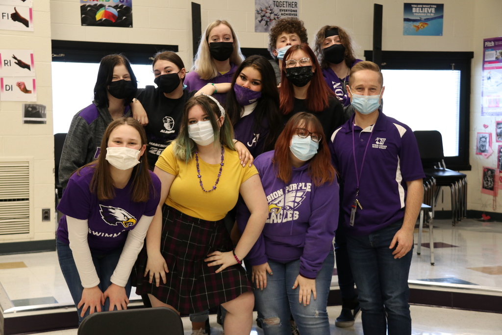 students pose in purple for spirit day
