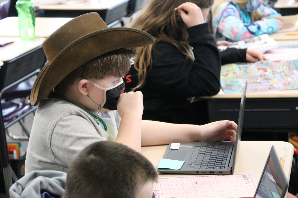 a student wears a cowboy hat in class