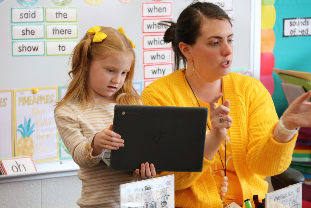 a teacher and student dressed in yellow