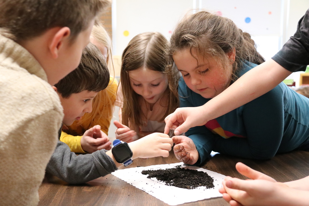 students get their hands dirty in dirt and worms
