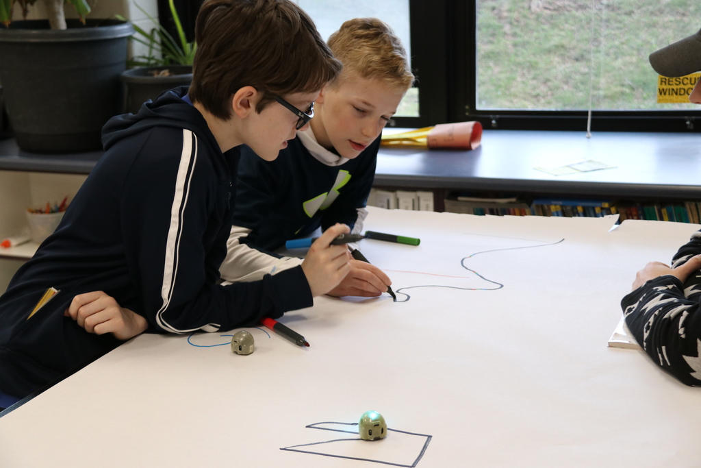 two students work on ozobot track