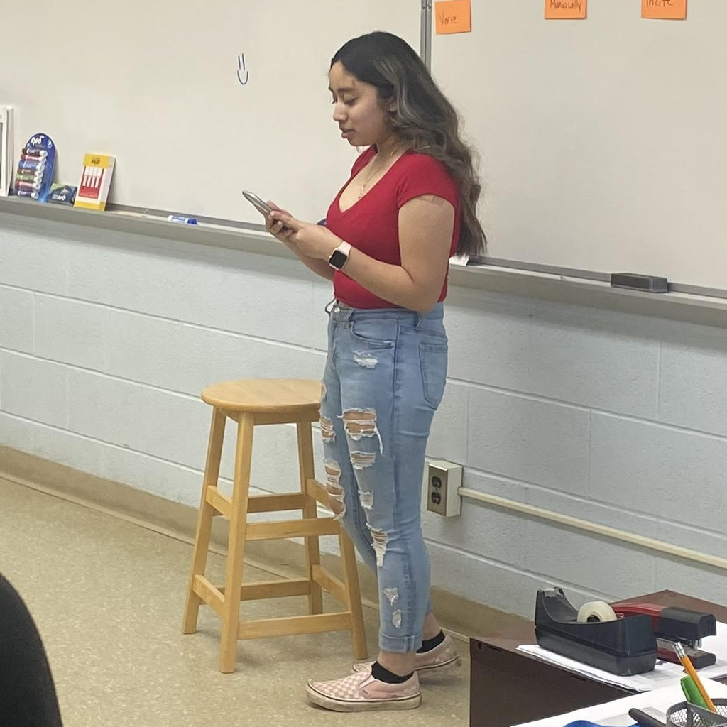 a student reads her poem to the class