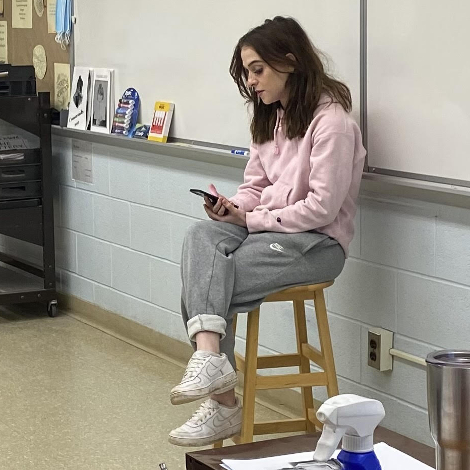 a student shares her poem with the class
