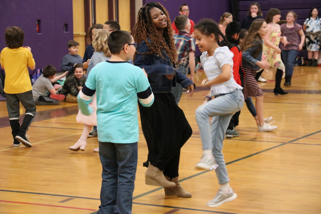 students dance and smile
