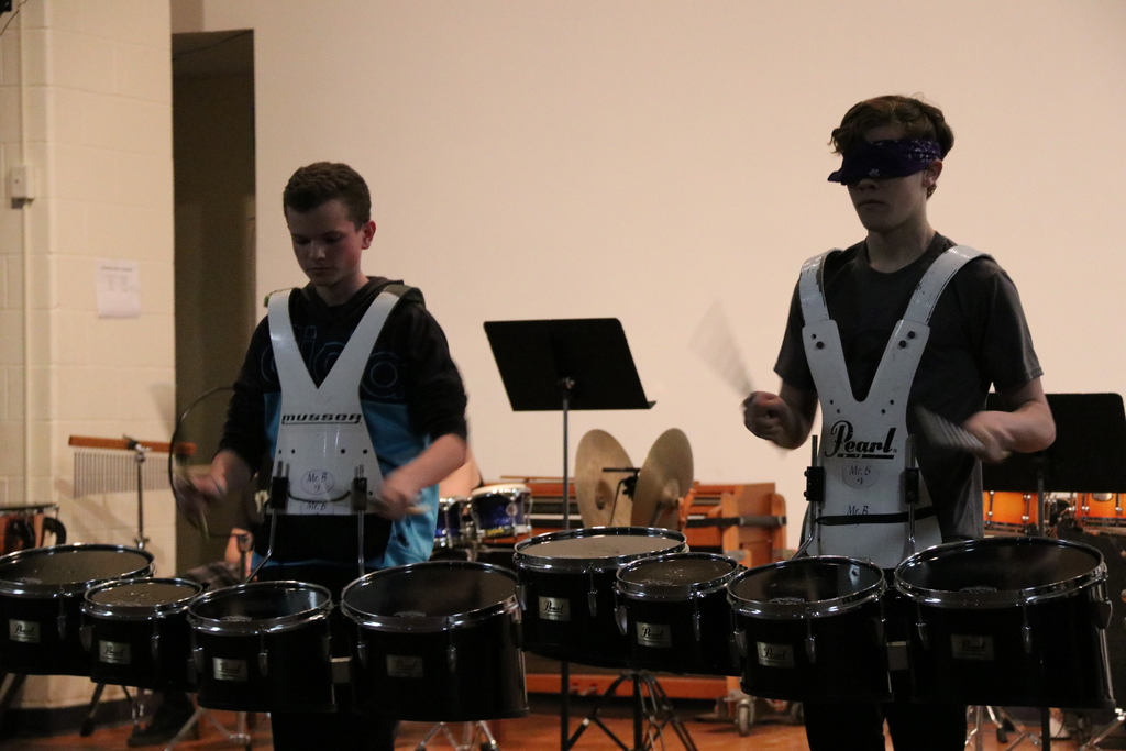 students play the drums