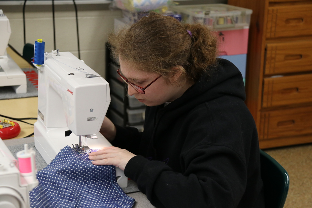 a student sews