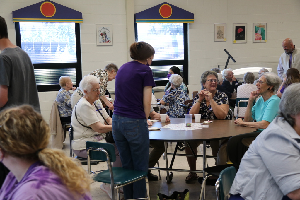 students chat with senior citizens