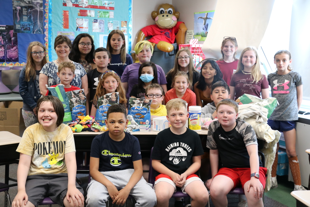 students gather around collected donations