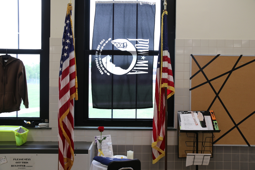 a POW-MIA flag with American flags on display