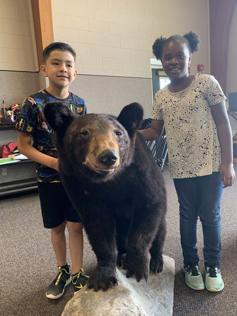 students pose with a taxidermy bear