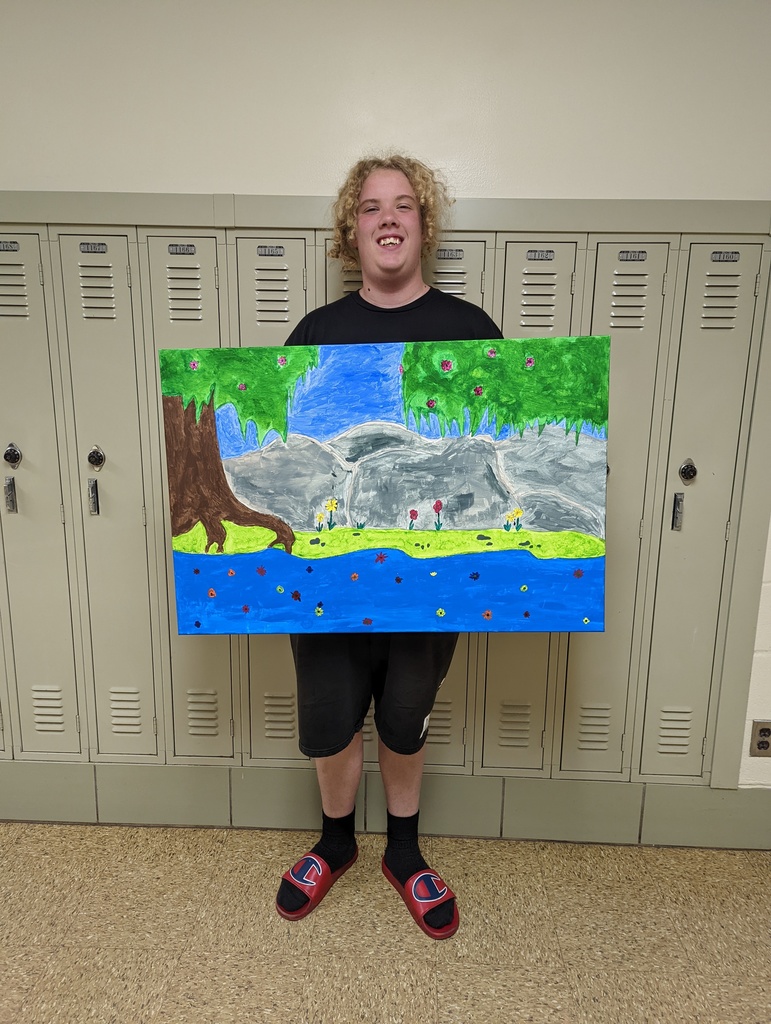 a student displays a painting