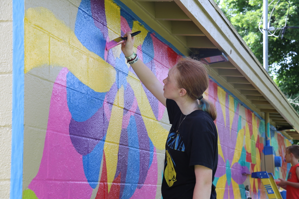 a student painting the mural