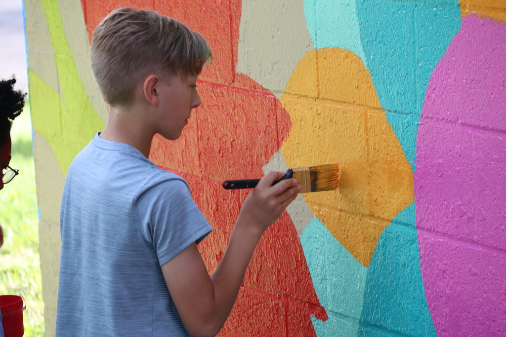 a student painting the mural