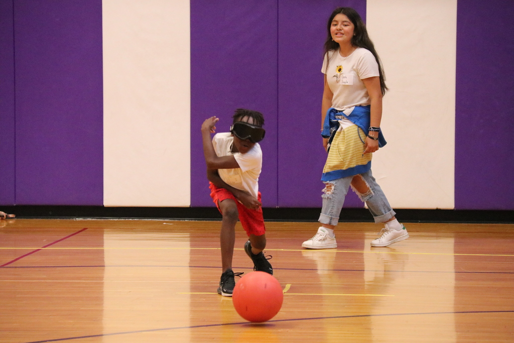 a blindfolded student roles a ball