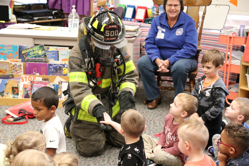 firefighter high-fives students