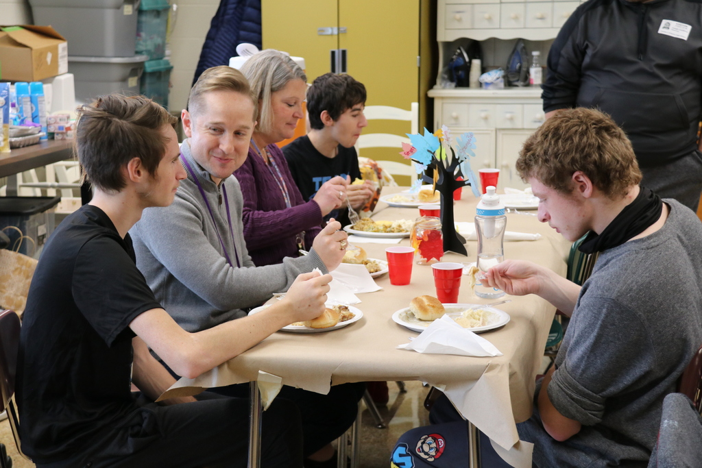 teachers and students share a meal