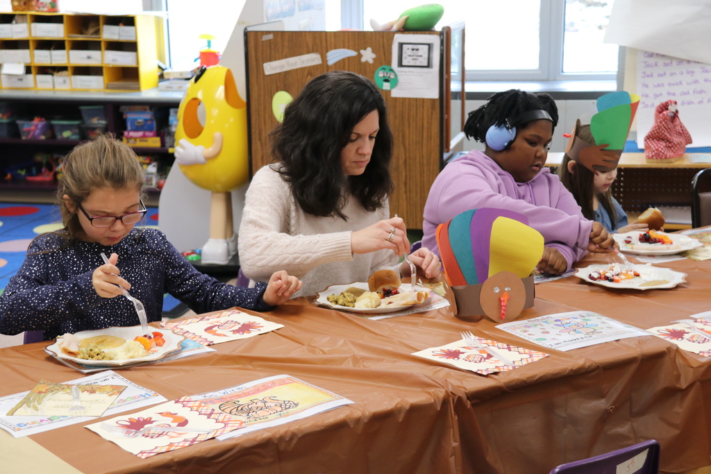 students and teacher share a meal