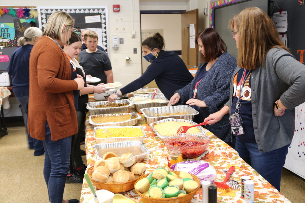 teachers serve food to students