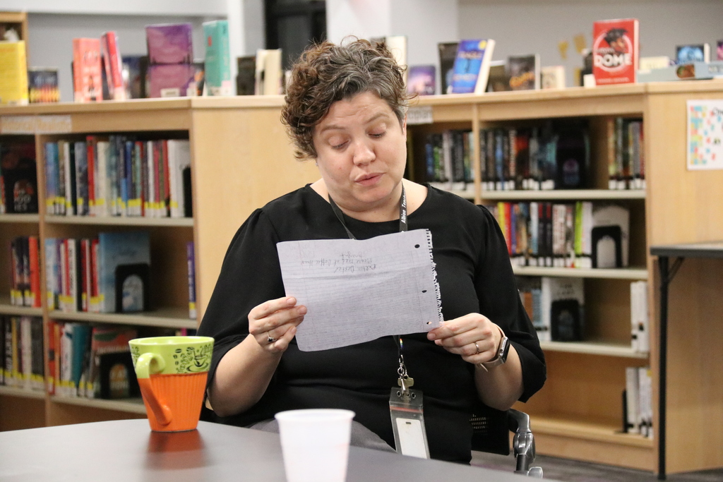teacher Mrs. Roche reads a student's poem