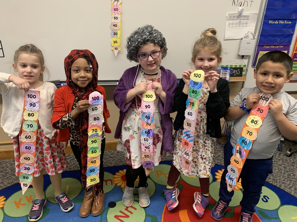student show their 100th day of school project