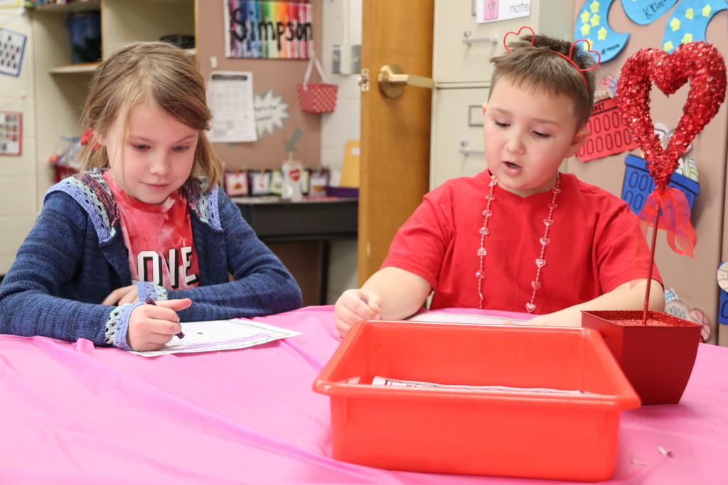 two students work on valentines craft