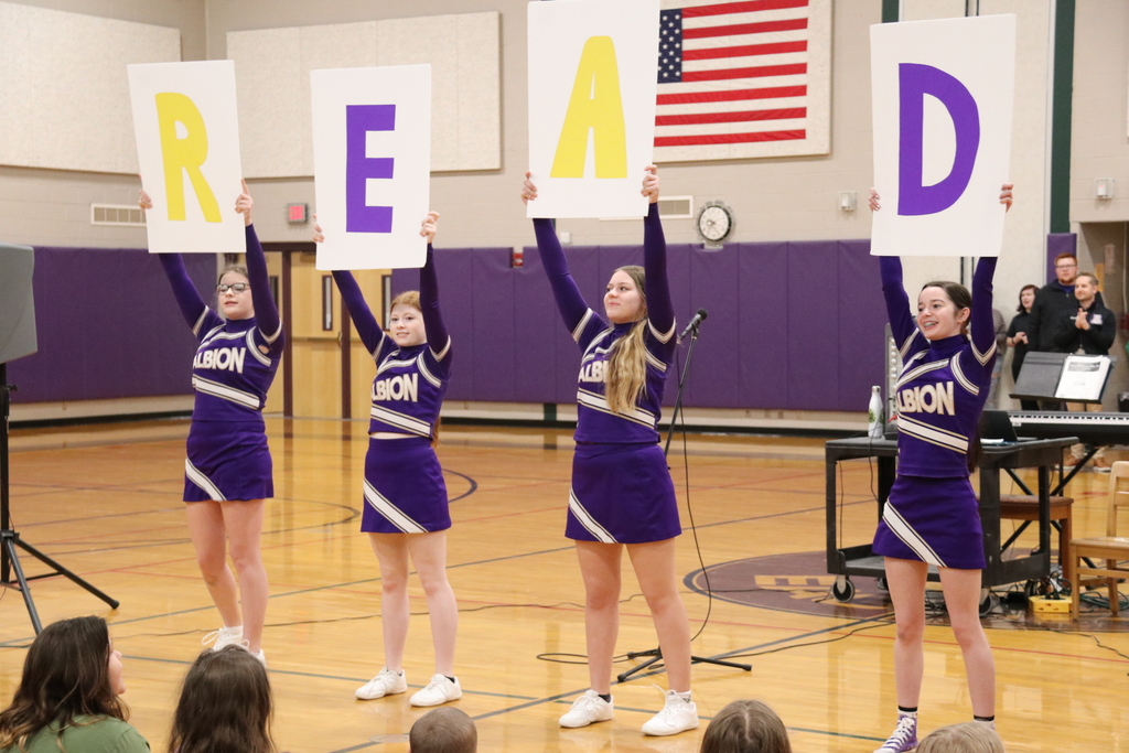 cheerleaders encourage the students to read
