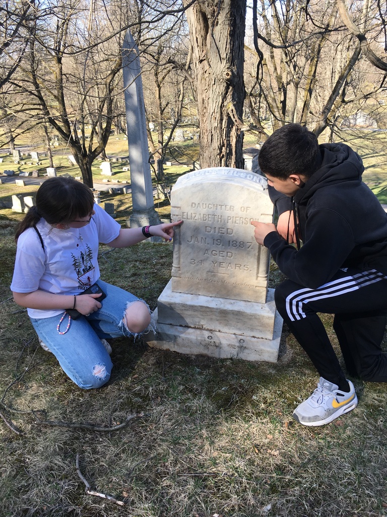 students look at a headstone